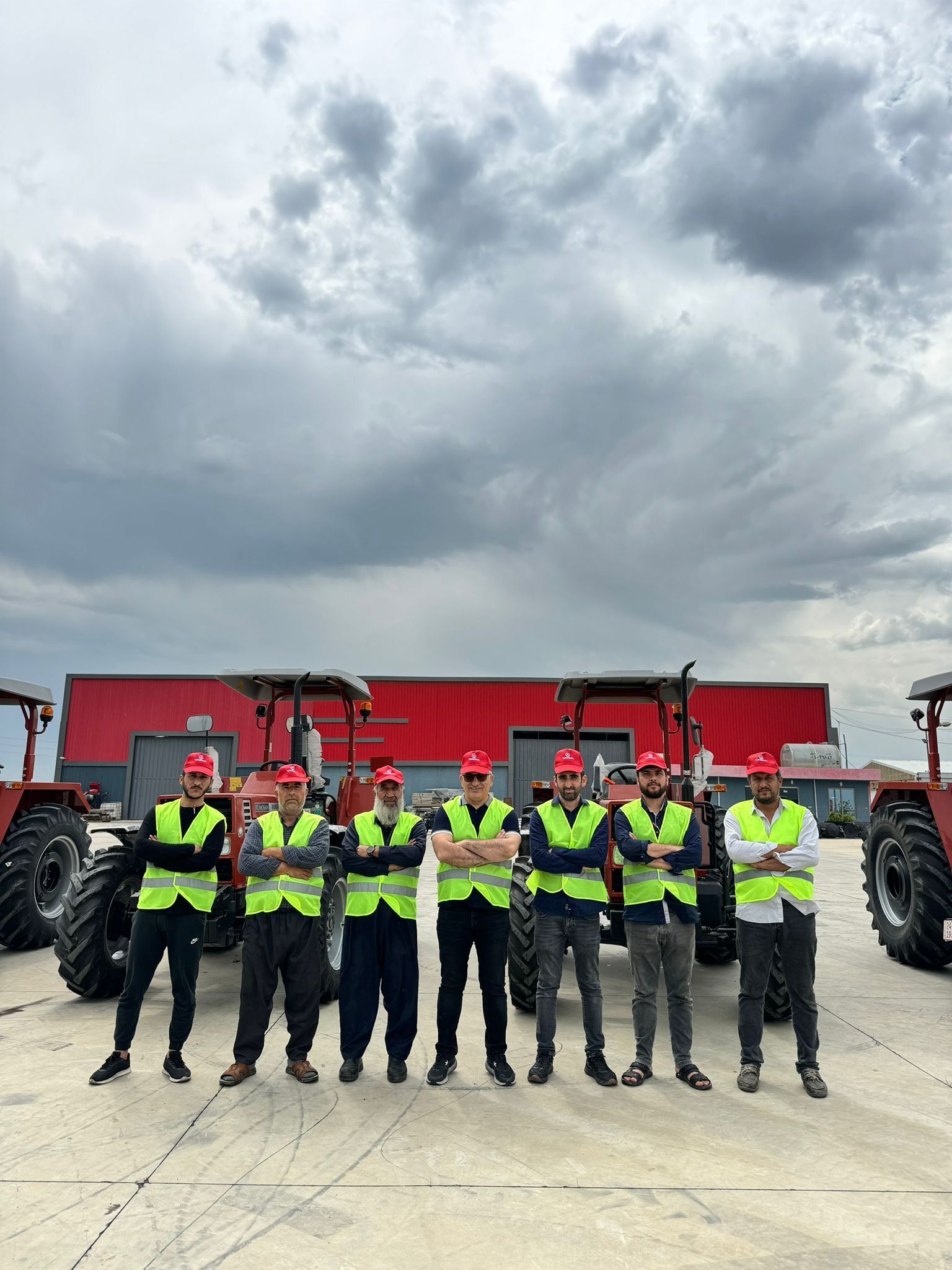 Gülharrin team members in high-visibility vests in front of the warehouse