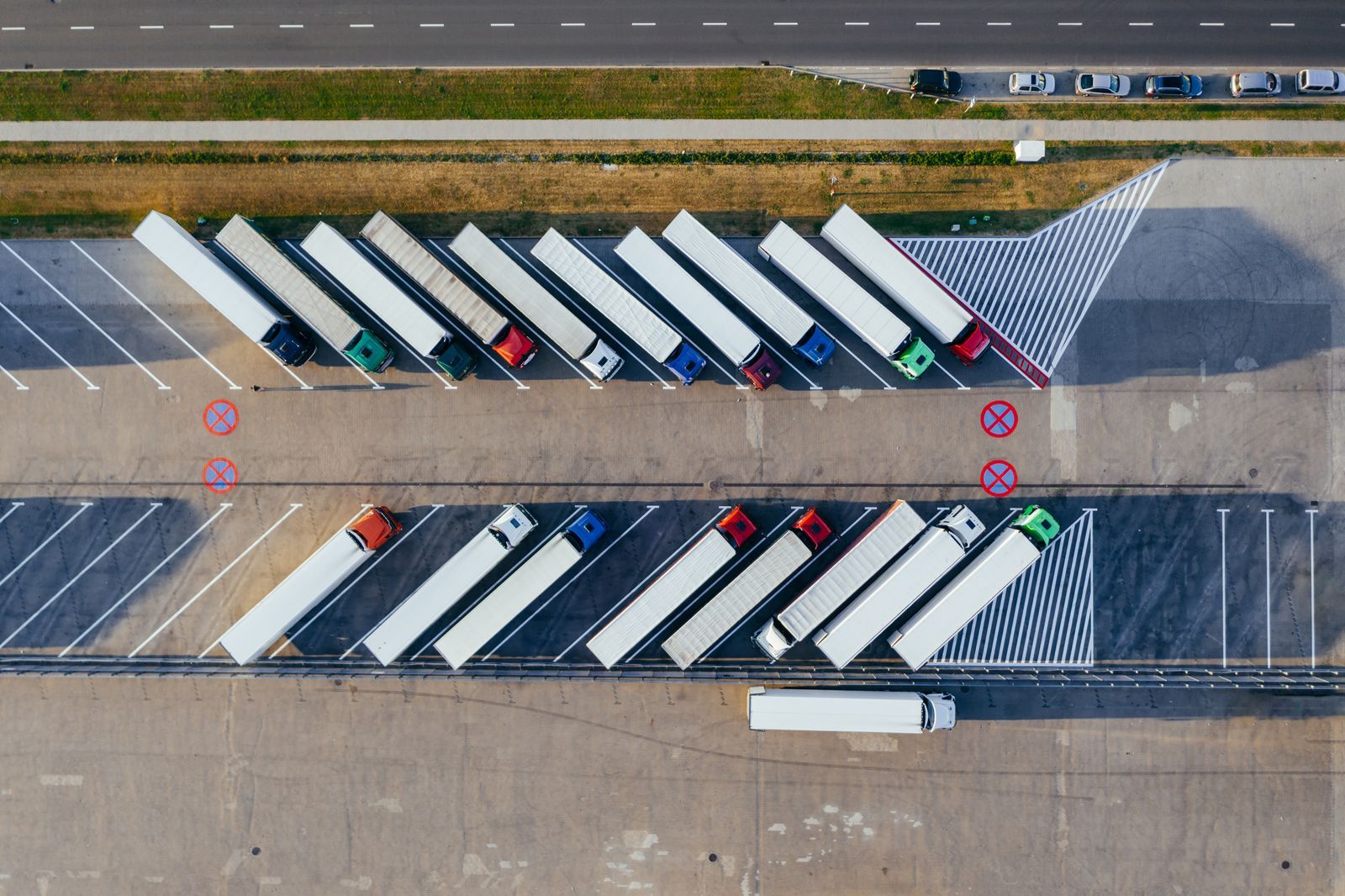 Aerial view of semi-trailers lined up at a transport depot